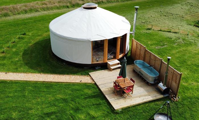 Stunning luxury yurt with the unique wood fired hippie hot tub, deck and firepit. With your own private shower, kitchen and flushing toilet.